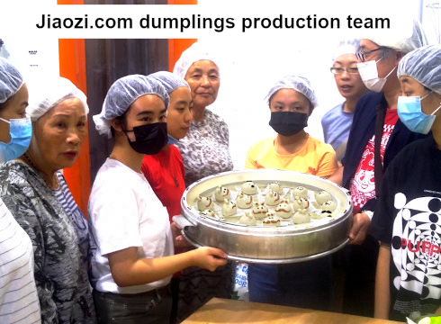 production team holding steamer tray