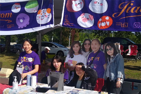 Early set up crew at BC dumpling fest 2023 3 younger volunteers and 4 parents